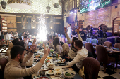 People gather on Christmas day at a restaurant in Damascus