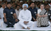 FILE PHOTO: Outgoing Indian PM Manmohan Singh along with India's Congress party chief Sonia Gandhi sit after paying respects at the Rajiv Gandhi memorial during the former Indian PM's 23rd death anniversary, in New Delhi