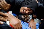 Mourners hold funeral for Palestinians who were killed in an Israeli raid, in Tulkarm