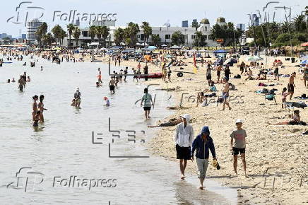 Beachgoers enjoy St Kilda beach