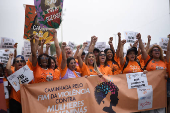 Demonstrators attend a walk, aimed to call for an end of violence against girls and women, in Copacabana beach in Rio de Janeiro