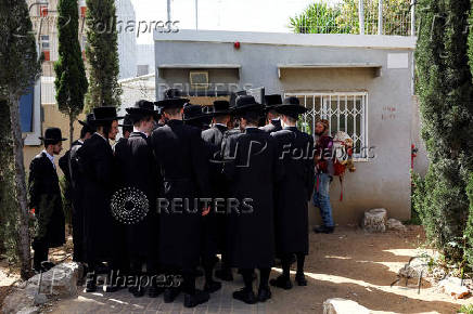 FILE PHOTO: Ultra-Orthodox Jews line up at an Israeli draft office to process their exemptions from mandatory military service at a recruitment base in Kiryat Ono
