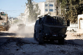 Israeli military vehicles operate during an Israeli raid in Tulkarm