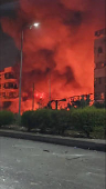 Smoke and flames rise near the hotel Beirut Golden Plaza in Beirut