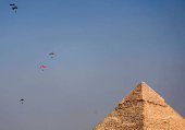 Professional skydivers fly over the historical site of Giza Pyramids, during Egypt International Skydiving Festival 