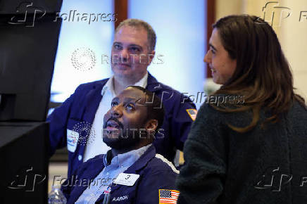 Traders work on the floor of the NYSE in New York