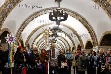 People dressed in traditional clothes sing carols inside a metro in Kyiv