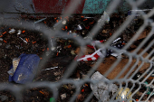 A tattered U.S. flag lies with used syringes and other drug paraphernalia in Bronx, New York City