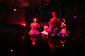 Performers dance inside a night club in Lagos