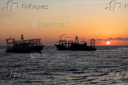 FILE PHOTO: Chinese Maritime Militia vessels are pictured near the Second Thomas Shoal in the South China Sea
