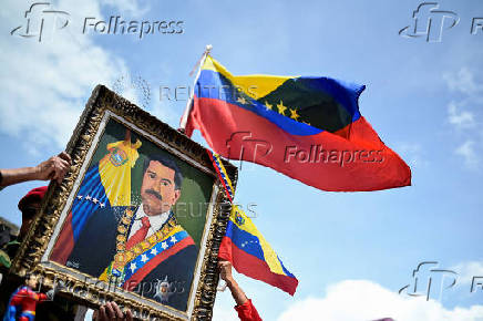 Government supporters participate in a march in support of Venezuelan President Nicolas Maduro's victory in the July 28 elections, in Caracas