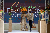 Models present clothing made from used cocoa sacks during the ninth edition of the National Cocoa and Chocolate Days in Abidjan