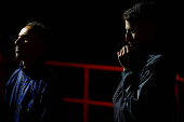 Migrants wait to disembark from a Spanish coast guard vessel, in the port of Arguineguin, on the island of Gran Canaria