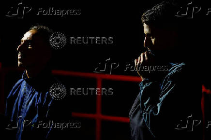 Migrants wait to disembark from a Spanish coast guard vessel, in the port of Arguineguin, on the island of Gran Canaria