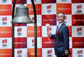 Akiyoshi Yamamura, President of Tokyo Metro, poses before ringing a bell at a ceremony to mark the company's debut on the Tokyo Stock Exchange in Tokyo