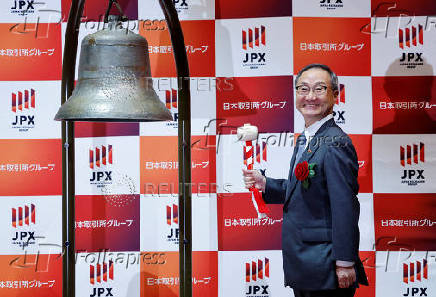 Akiyoshi Yamamura, President of Tokyo Metro, poses before ringing a bell at a ceremony to mark the company's debut on the Tokyo Stock Exchange in Tokyo