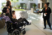 First-time voter Yeshua Loya with his sister Hadassah and mom Mariana Sanchez speak with Monica Murray, Supervisor for the Special Election Board, in Scottsdale