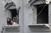 Palestinians inspect damage at the site of an Israel strike on a house, at Nuseirat refugee camp