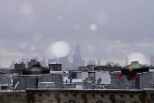 One World Trade Center and the Lower Manhattan skyline is seen during the city's first snowfall of the season, in the Queens borough of New York City