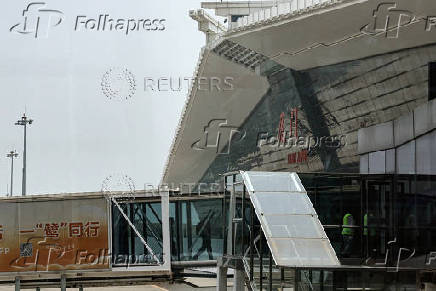 Passengers get off an airplane at the Xiamen Gaoqi International Airport
