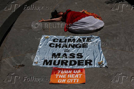 A climate control activists demonstrates outside the global headquarters of Citigroup in New York City