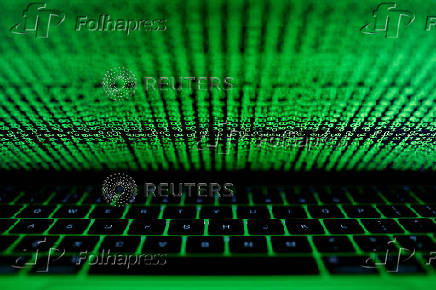 FILE PHOTO: A computer keyboard lit by a displayed cyber code is seen in this illustration picture
