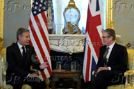 Britain's Prime Minister Keir Starmer listens to U.S. Secretary of State Antony Blinken as they meet at Lancaster House in London