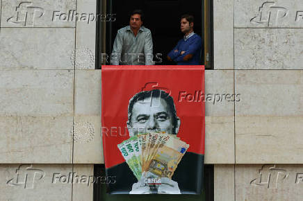 Far-right political party Chega expose banners on the facade of the Portuguese parliament against the wage reinstatement for politicians after the cuts imposed by the Troika, during the debate and vote of the 2025 budget bill on final reading, in Lisbon