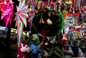 Women shop for Christmas decorations at a roadside market in Ahmedabad,