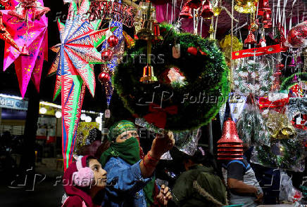 Women shop for Christmas decorations at a roadside market in Ahmedabad,