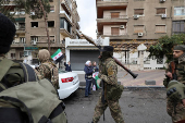 Khaled Brigade, a part of Hay'at Tahrir al-Sham (HTS), hold a military parade, in Damascus