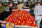 People shop for fruits and vegetables at a market in Taipei
