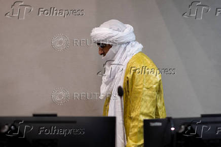 Al Hassan Ag Abdoul Aziz Ag Mohamed Ag Mahmoud enters the courtroom of the International Criminal Court in The Hague