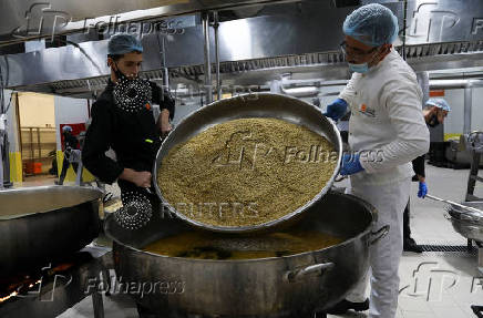 Workers prepare iftar meals to be delivered to Gaza, in Amman