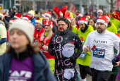 Runners wearing Santa Claus-themed outfits take part in the 