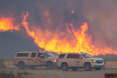 Firefighters and aircraft battle the Hughes Fire near Santa Clarita