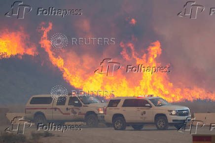 Firefighters and aircraft battle the Hughes Fire near Santa Clarita