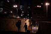 A woman and children walk down a staircase in Sao Paulo