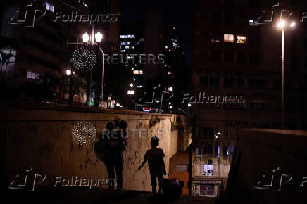 A woman and children walk down a staircase in Sao Paulo