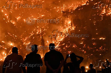 Wildfire burns next to the village of Kallithea, near Corinth