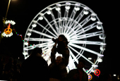 People take photos on the Golden Mile during Diwali celebrations in Leicester