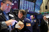 Traders work on the floor of the NYSE in New York