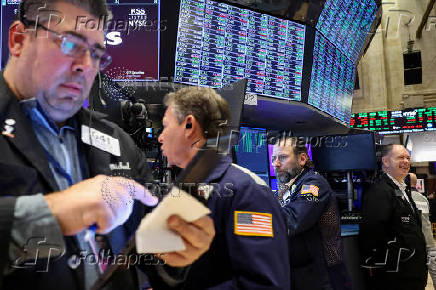 Traders work on the floor of the NYSE in New York