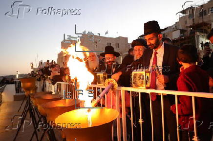 Hostages' families participate in lighting of first Hanukkah candle at Western Wall in Jerusalem