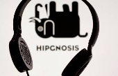 FILE PHOTO: Headset seen in front of displayed Hipgnosis logo in this illustration taken