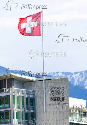 A Swiss flag flutters on the headquarters of Nestle in Vevey