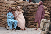 Labourers cover themselves with shawls, in Karachi