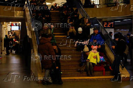 People take shelter inside a metro station during a Russian military strike, in Kyiv