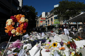 Floral tributes for victims of attack lay outside the Westfield Bondi Junction shopping centre in Sydney