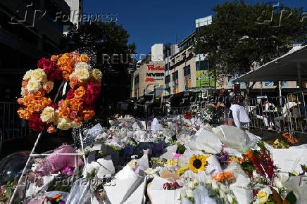 Floral tributes for victims of attack lay outside the Westfield Bondi Junction shopping centre in Sydney